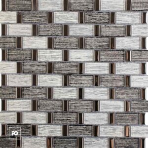 Close-up of a decorative wall tiling pattern with light and dark rectangular bricks and small bronze metal accents.