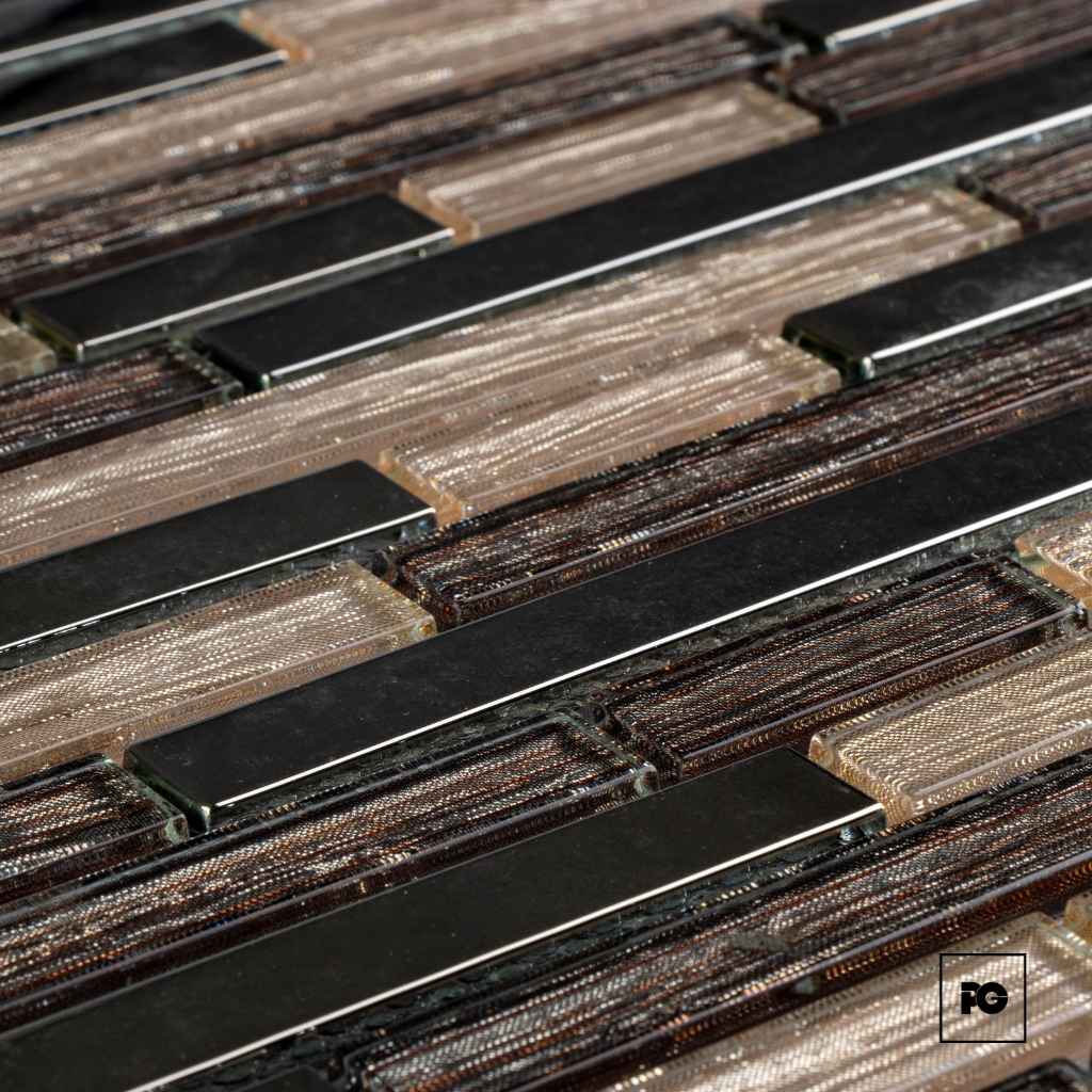 Close-up of copper traces and black rectangular chips embedded in flexible printed circuit boards.